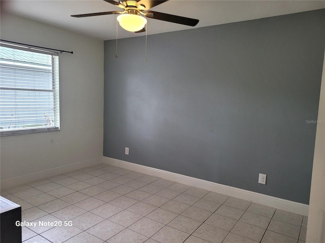 tiled spare room with ceiling fan