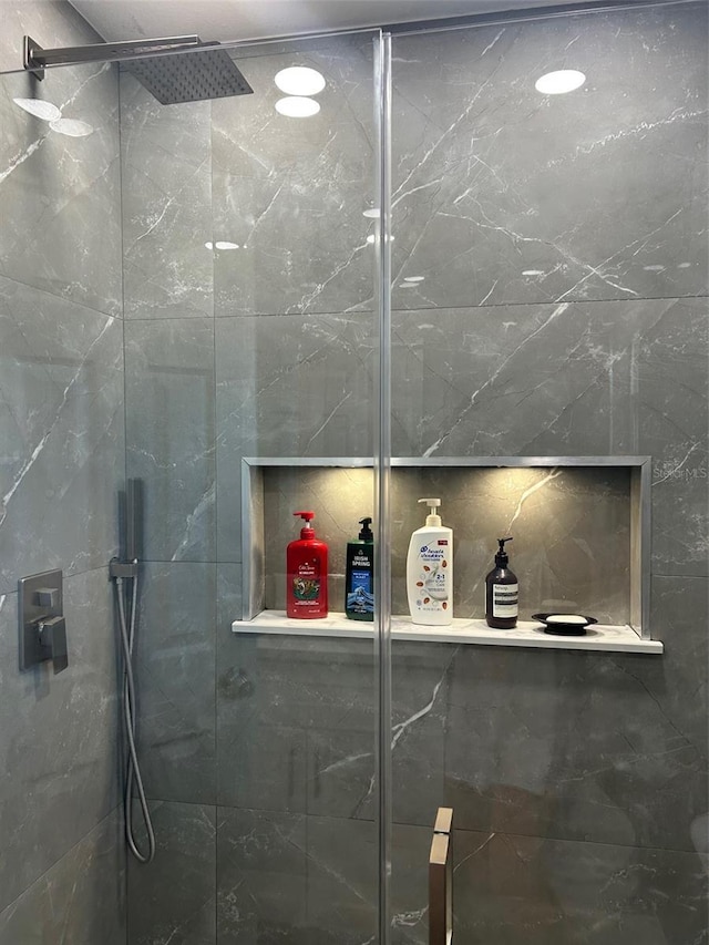 bathroom with a shower with door