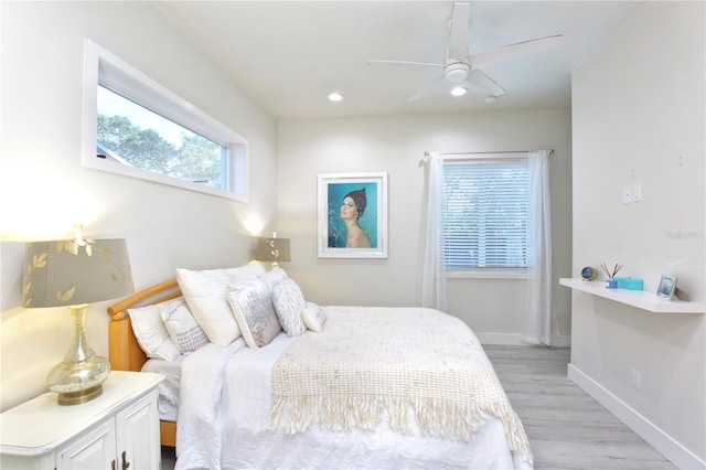 bedroom with light hardwood / wood-style flooring and ceiling fan