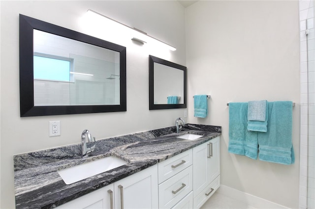 bathroom with vanity and tiled shower