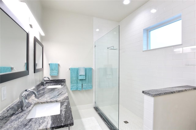 bathroom with vanity and tiled shower