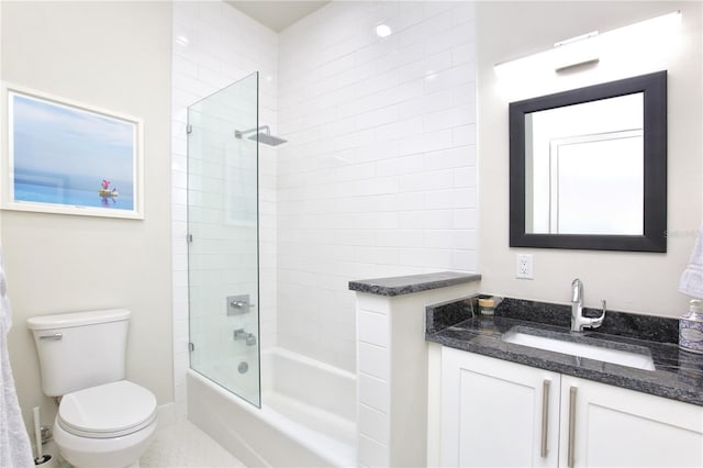 full bathroom featuring vanity, tiled shower / bath combo, and toilet