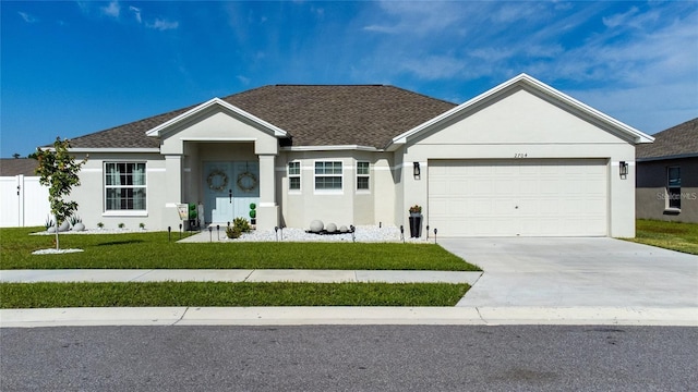 ranch-style home featuring a garage and a front yard