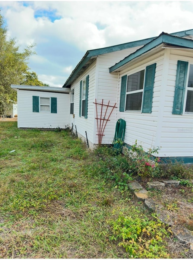 view of property exterior featuring a lawn