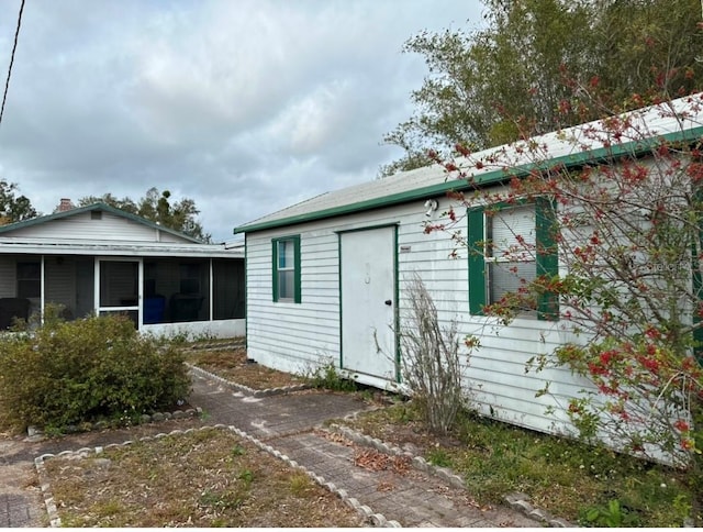 back of house with a sunroom