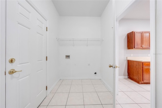 clothes washing area featuring electric dryer hookup, hookup for a washing machine, and light tile patterned floors