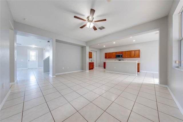 unfurnished living room with ceiling fan and light tile patterned flooring