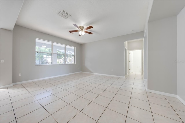 empty room featuring ceiling fan and light tile patterned flooring