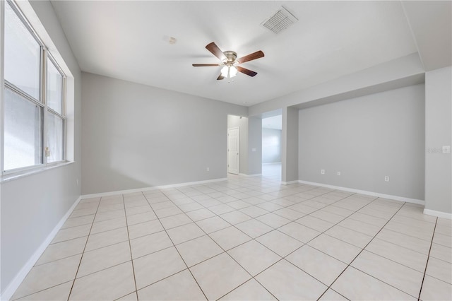 empty room featuring ceiling fan and light tile patterned floors