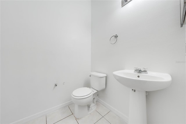 bathroom featuring tile patterned flooring, toilet, and sink