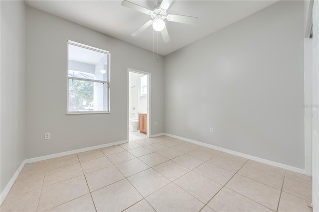 tiled spare room with ceiling fan