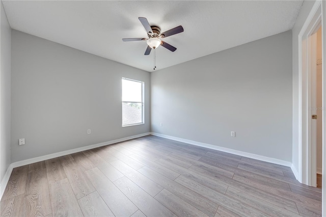 spare room featuring ceiling fan and light hardwood / wood-style floors