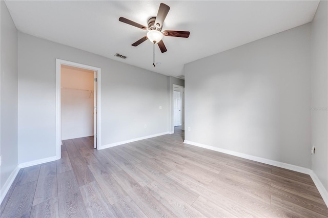 empty room featuring ceiling fan and light wood-type flooring