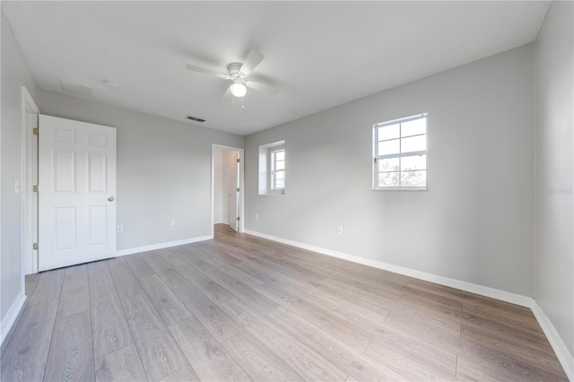 spare room featuring ceiling fan and light hardwood / wood-style flooring