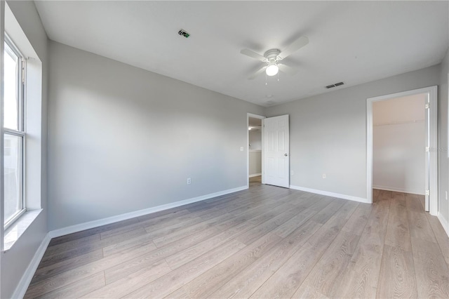 interior space featuring light wood-type flooring, ceiling fan, and a healthy amount of sunlight