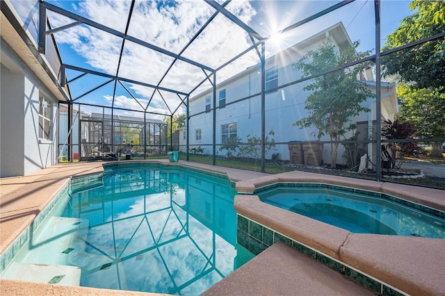 view of swimming pool with an in ground hot tub and a lanai