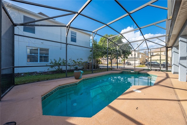 view of swimming pool with a patio area, a lanai, and an in ground hot tub