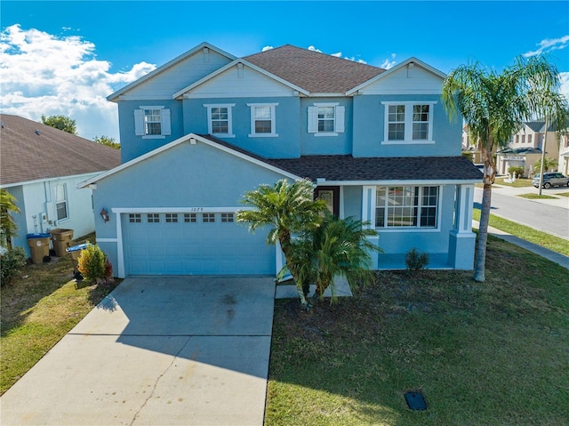 view of front of home featuring a front yard and a garage