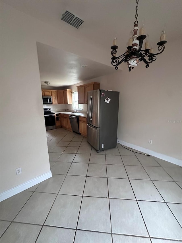 kitchen with light tile patterned flooring and stainless steel appliances