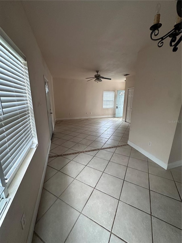 unfurnished living room featuring ceiling fan and light tile patterned floors