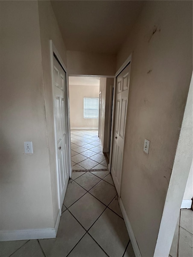 corridor with light tile patterned floors