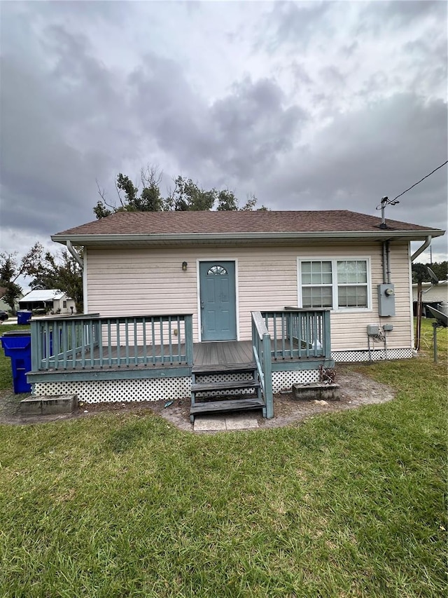 exterior space featuring a front lawn and a deck