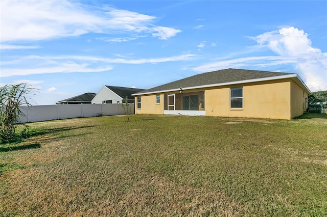 back of house featuring a yard