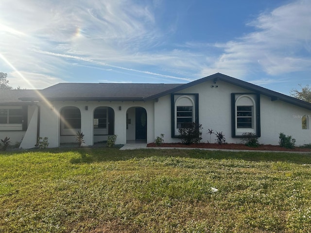 single story home featuring a front yard