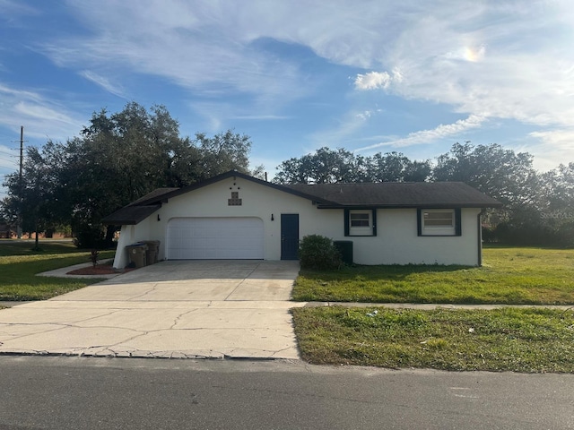 ranch-style home with cooling unit, a garage, and a front lawn