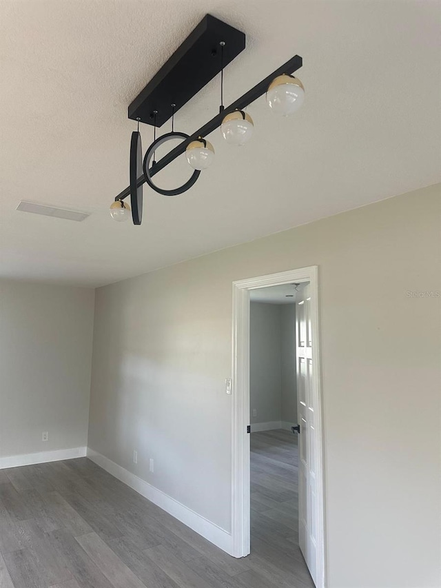 empty room featuring dark wood-type flooring and a textured ceiling