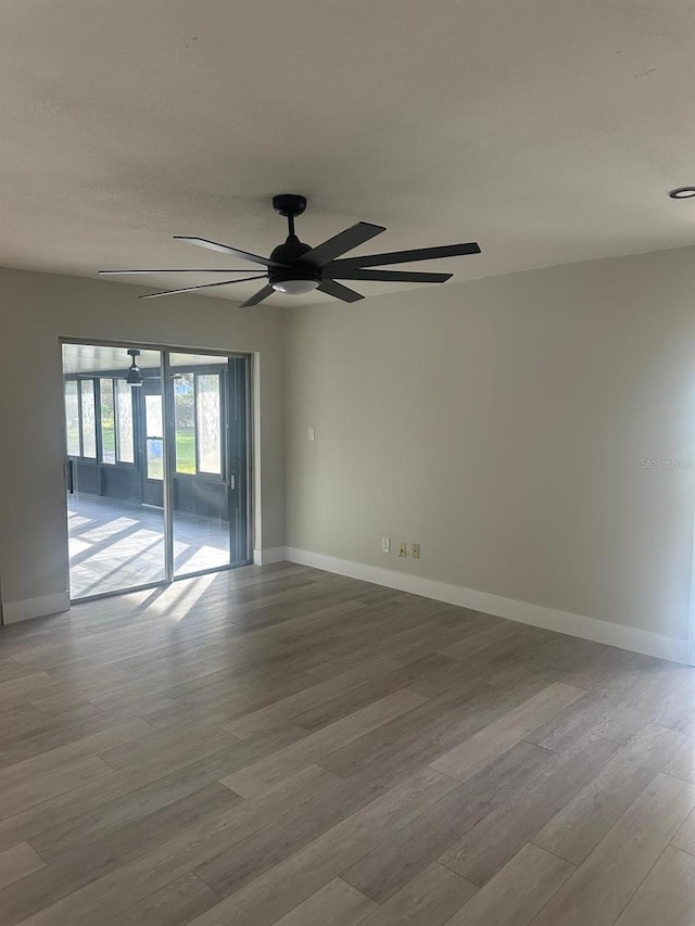 spare room with ceiling fan and light hardwood / wood-style floors