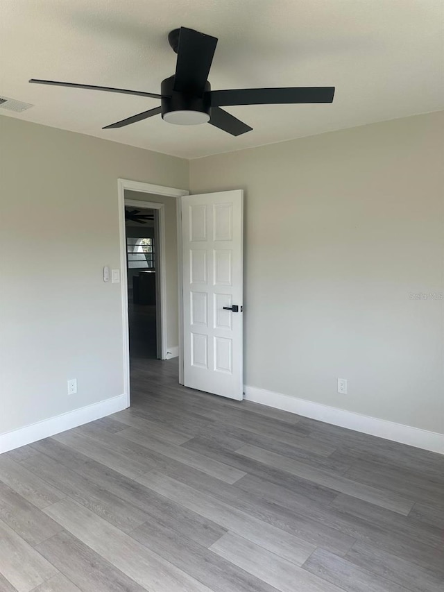 spare room featuring ceiling fan and light hardwood / wood-style floors