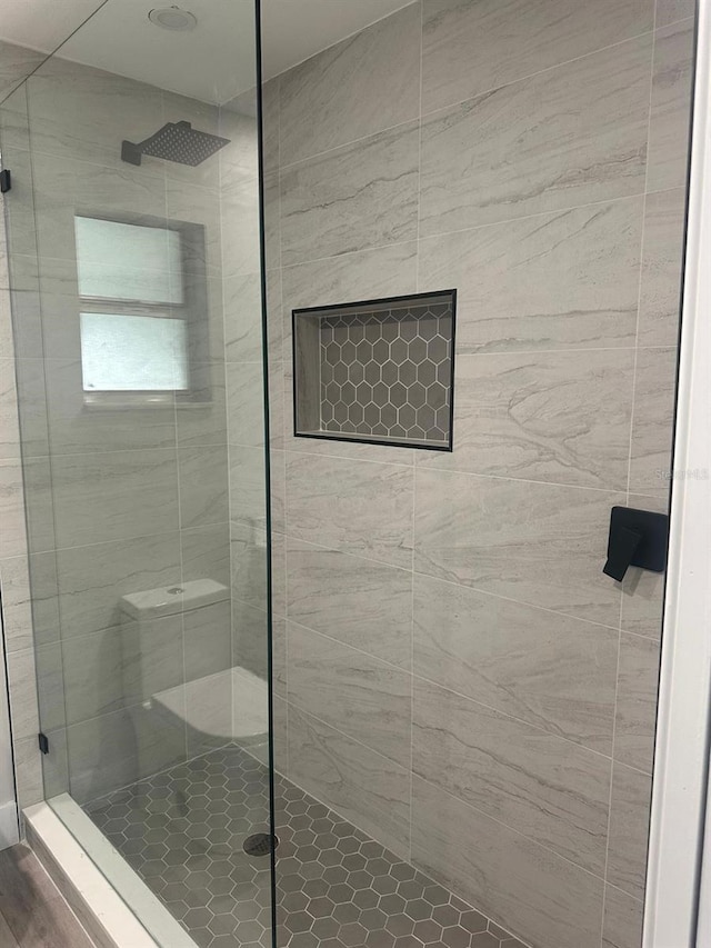 bathroom with a tile shower