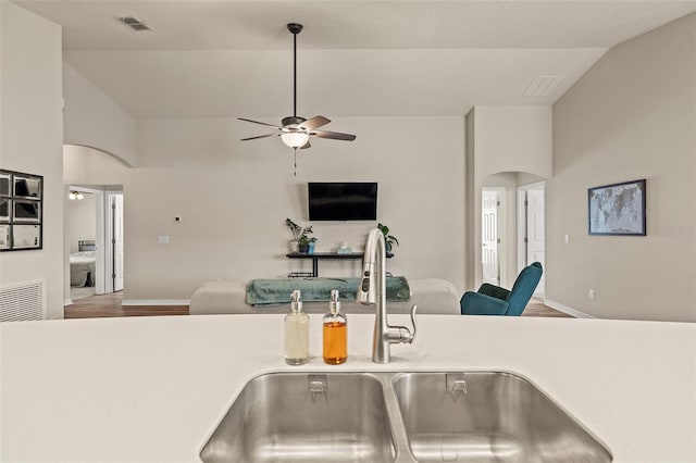 kitchen featuring hardwood / wood-style flooring, ceiling fan, sink, and high vaulted ceiling