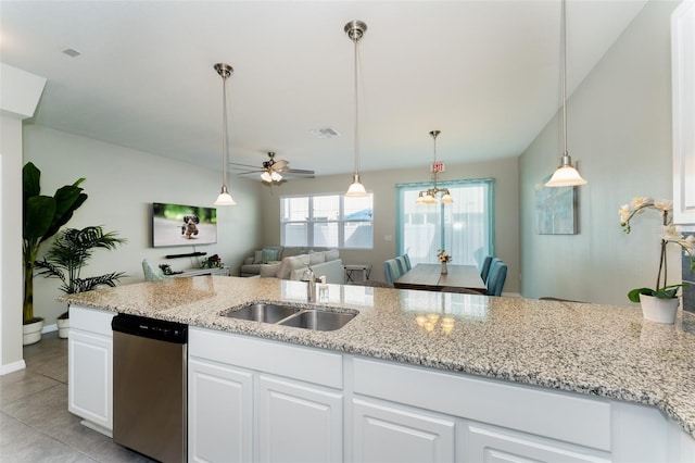 kitchen featuring light stone countertops, stainless steel dishwasher, ceiling fan with notable chandelier, sink, and white cabinets