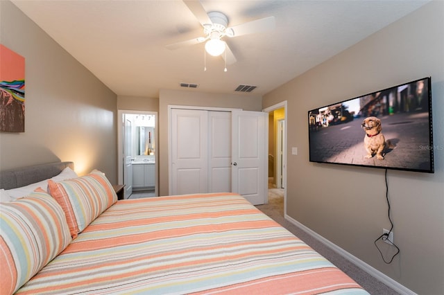 bedroom featuring carpet flooring, a closet, ensuite bath, and ceiling fan