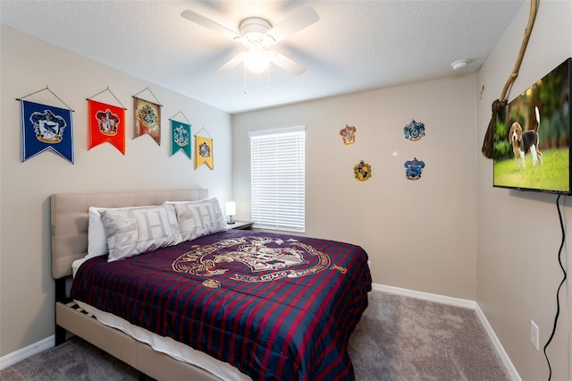 carpeted bedroom featuring a textured ceiling and ceiling fan