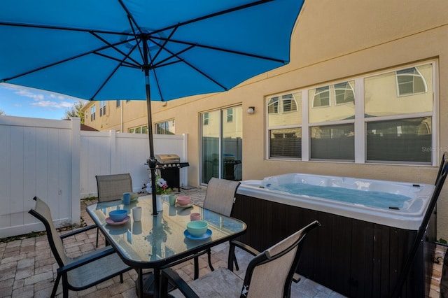 view of patio featuring a grill and a hot tub