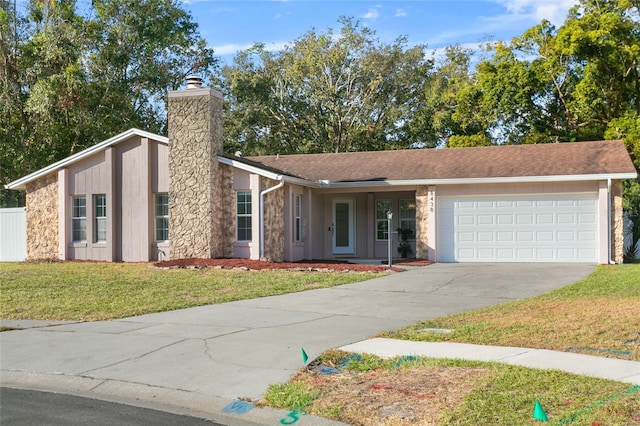 single story home with a garage and a front lawn