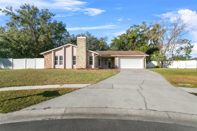 view of front facade featuring a front yard and a garage