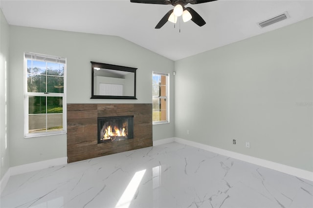 unfurnished living room with ceiling fan, plenty of natural light, and vaulted ceiling