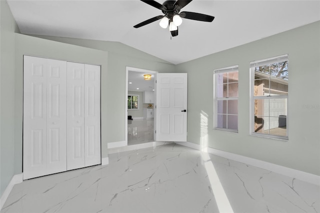 unfurnished bedroom featuring ceiling fan, lofted ceiling, and a closet