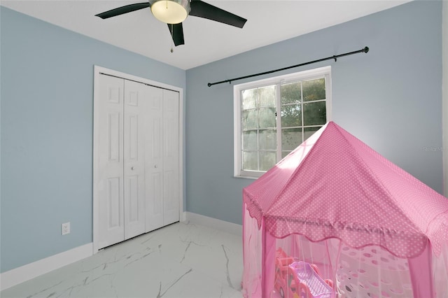 bedroom featuring ceiling fan and a closet