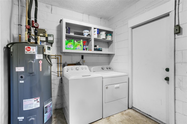 laundry room with washing machine and dryer, a textured ceiling, and water heater