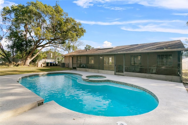 view of swimming pool featuring an in ground hot tub, a patio area, and a sunroom