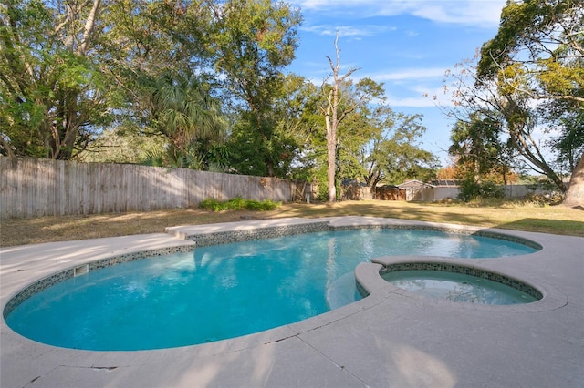 view of pool featuring an in ground hot tub