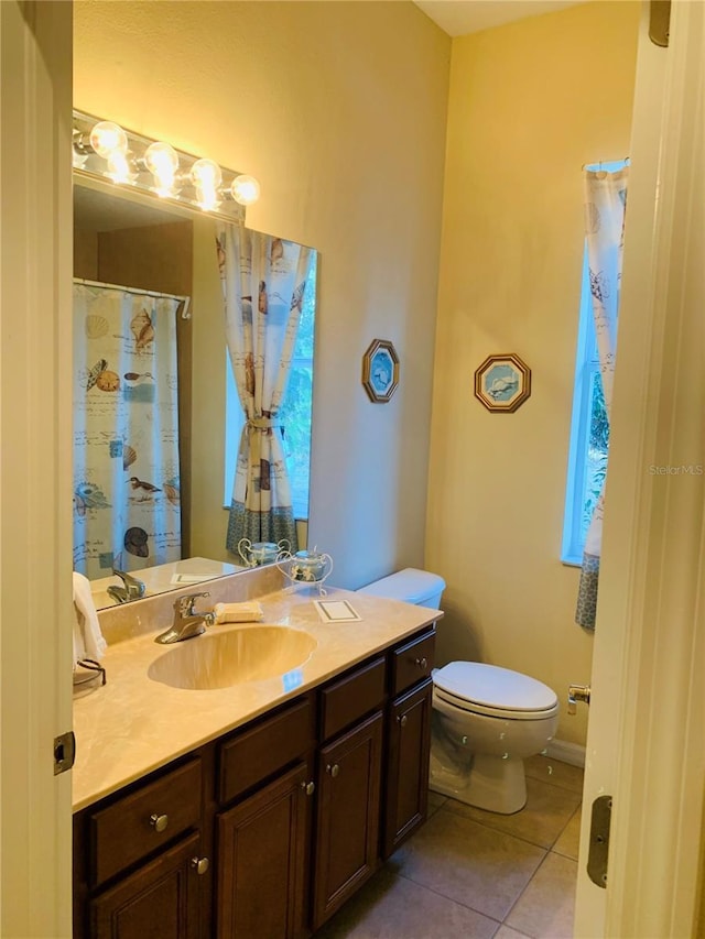 bathroom featuring vanity, toilet, and tile patterned flooring