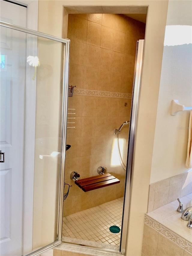 bathroom with a shower with shower door