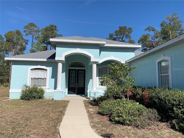 view of front facade with a front lawn and a porch