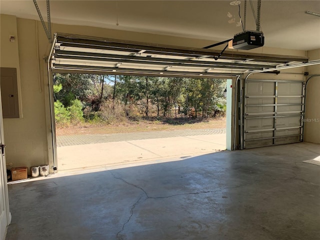 garage with electric panel and a garage door opener